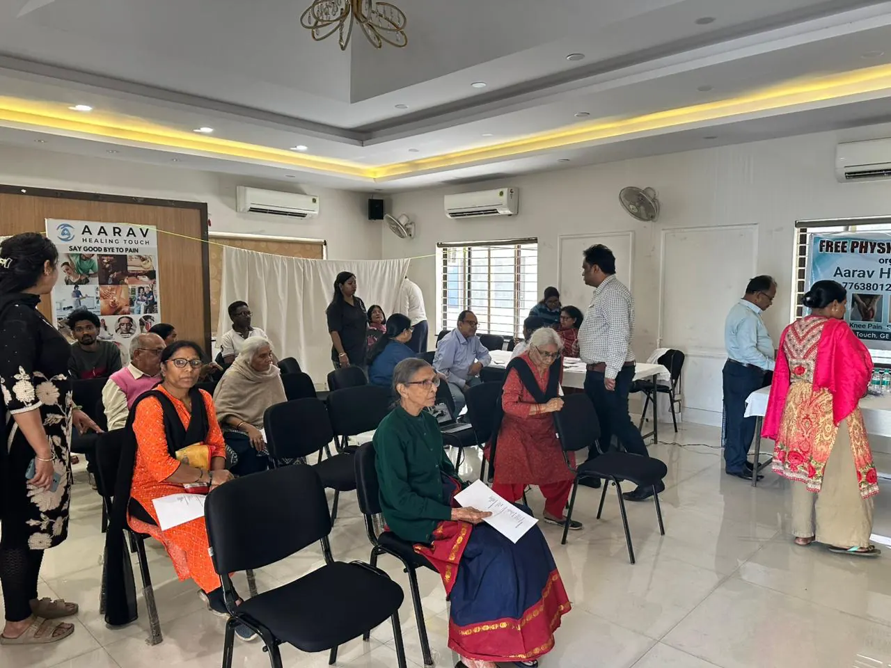 Elderly participants seated at an Aarav Healing Touch camp
