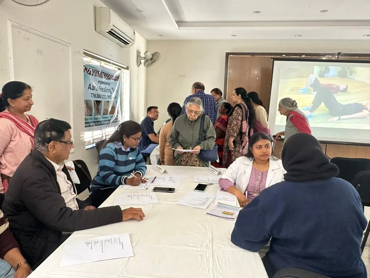 Healthcare professionals consulting participants at a community camp